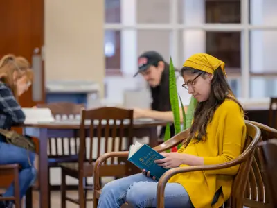young woman reading book