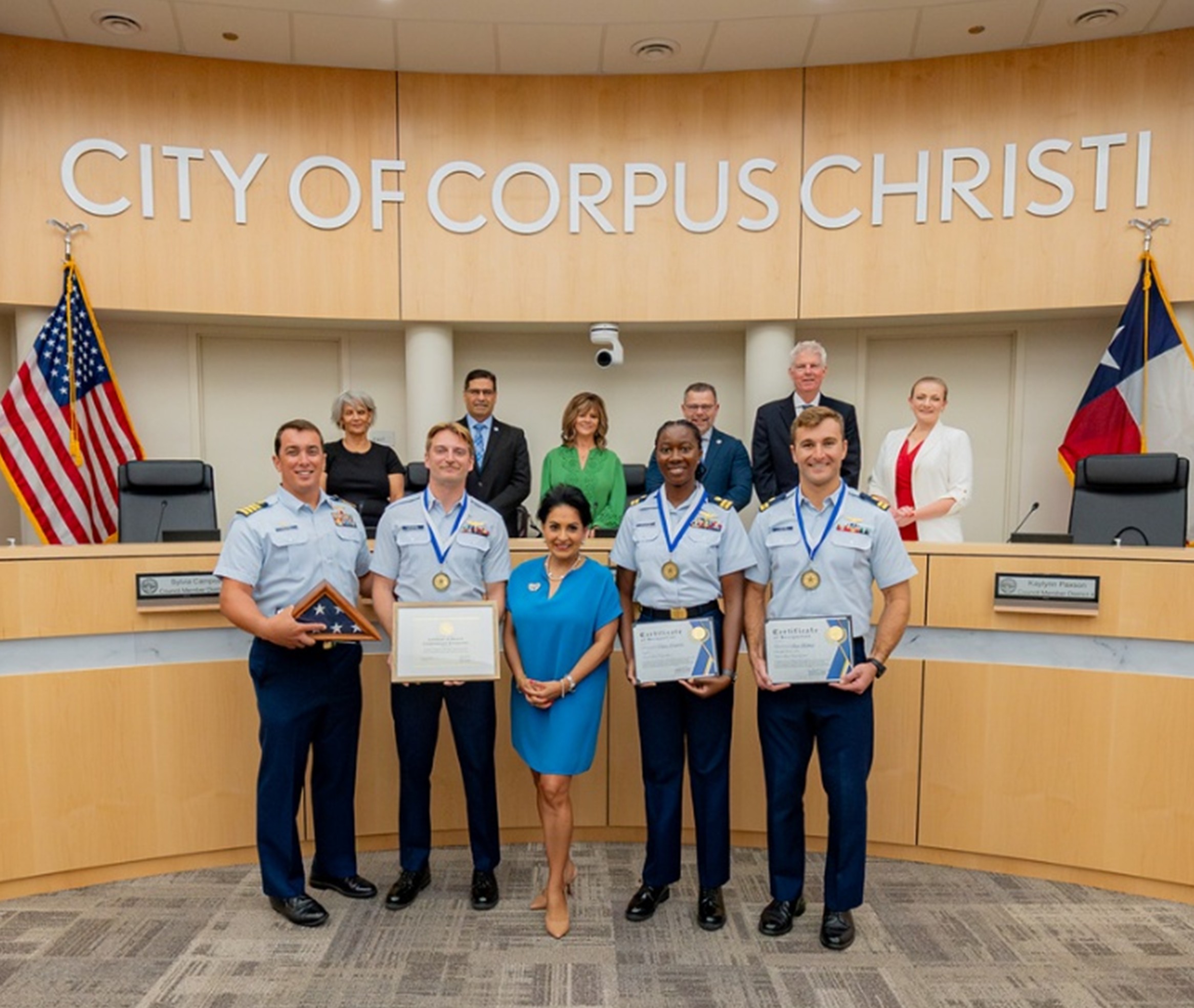 Coast Guard pose with certificate alongside Mayor Paulette Guajardo