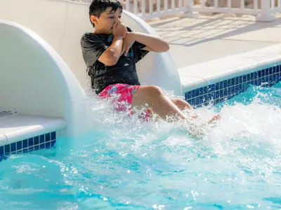 Boy slides into pool